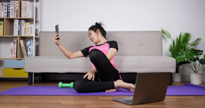 Woman trainer taking selfie with smartphone