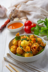 deep fried wonton on the white wooden background.