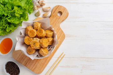 Deep fried fhicken roll on the white wooden background.