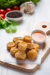 Deep fried fhicken roll on the white wooden background.