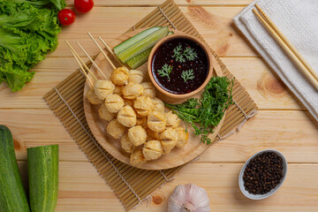 Pork meatballs on the wooden background.