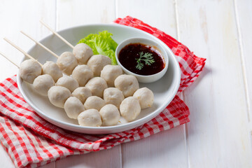 Pork meatballs on the white wooden background.