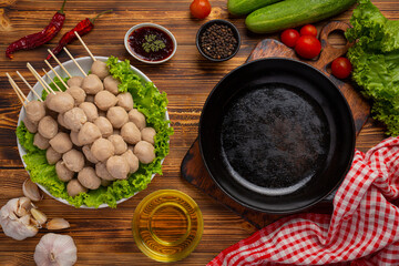 Beef ball fried on the dark wooden background.
