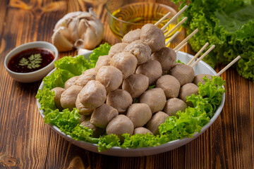 Beef ball fried on the dark wooden background.