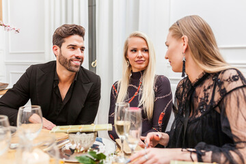Group of friends conversating during dinner