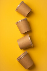 No plastic glasses for delivery on yellow background