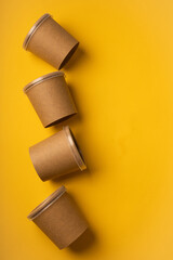 No plastic glasses for delivery on yellow background