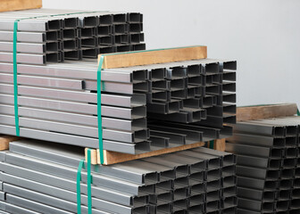 heap of C shape stainless steel bar. raw meterial for steel structure. pile of chanel metal bar.