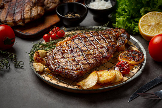 Grilled beef steak steak on the dark background.