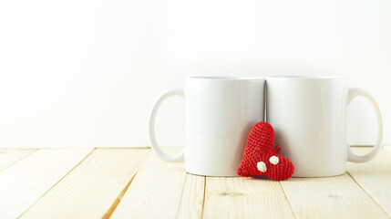 Two white mugs together with a heart in the center.