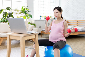 Fototapeta na wymiar Pregnant woman workout online