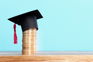 Black Graduation cap over stack of coins