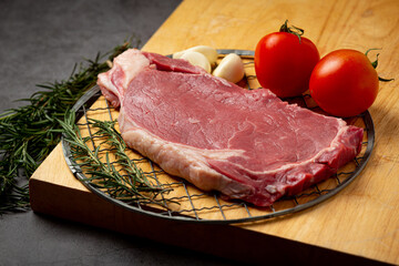 fresh raw beef steak on the dark background.