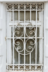 Old monastery window grate. White painted metal window grill of church building. Russian traditional architecture fragment. Kostroma, Golden ring, Russia 