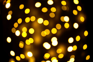 Abstract festive elegant background of blurred with bokeh lights on brown background, defocused