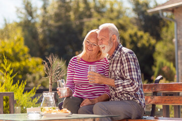 Senior couple drinking lemonade in the backyard