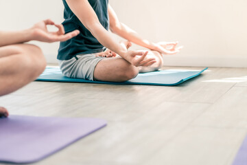 Diversity group of people do yoga workout together. Close up shot hand of male in yoga lotus pose