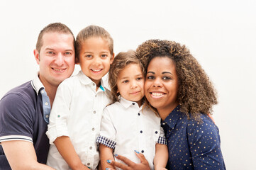Happy multiracial family with two children, on the white background
