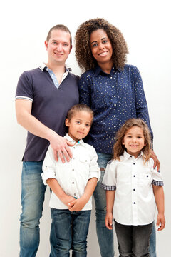 Happy multiracial family with two children, on the white background