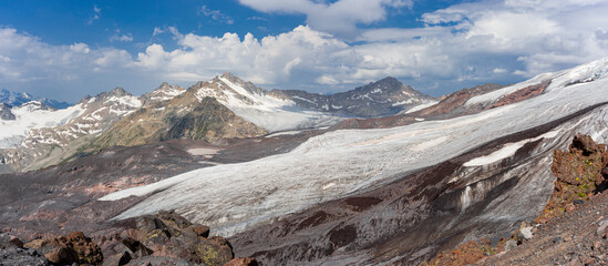 Panoramic view of the Elbrus glaciers. In the foreground is the Azau glacier. Southwest side of Elbrus. Altitude 3500 m. July 2020