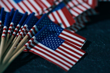some american flags on a dark surface