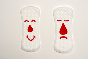 Pair of menstrual pads with faces, isolated on white background. 