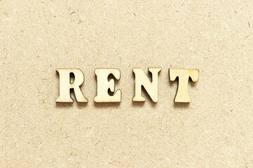 Alphabet letter in word rent on wood background