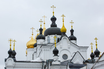 Fototapeta na wymiar Black and gold domes of white Epiphany monastery of St. Anastasia cathedral. Ancient Russian orthodox building. Kostroma, Golden Ring, Russia. Horizontal orientation. 