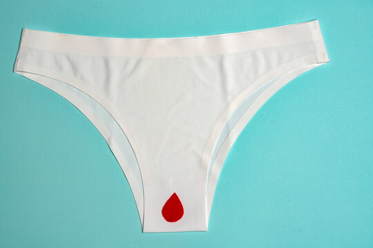 White underwear with a red drop, isolated on blue.