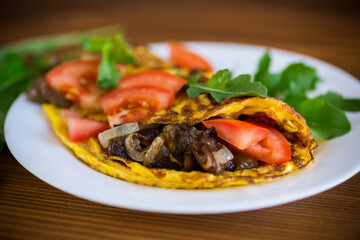 fried egg omelet with wild mushrooms and tomatoes