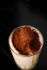 milk cocktail with cocoa and ice, top view