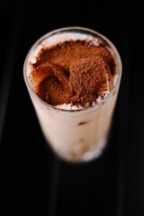 milk cocktail with cocoa and ice, side view