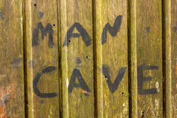 Man Cave sign on a shed door
