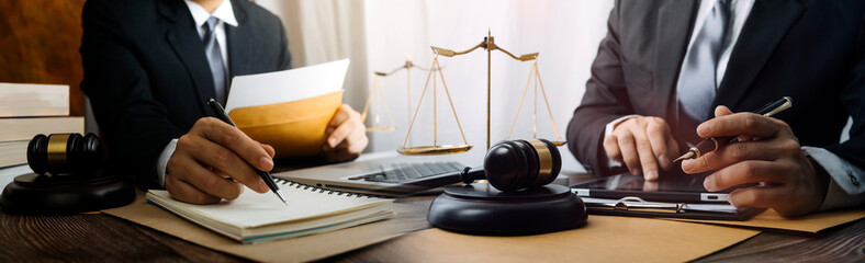 Business and lawyers discussing contract papers with brass scale on desk in office. Law, legal...