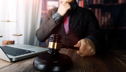 Business and lawyers discussing contract papers with brass scale on desk in office. Law, legal services, advice, justice and law concept picture with film grain effect