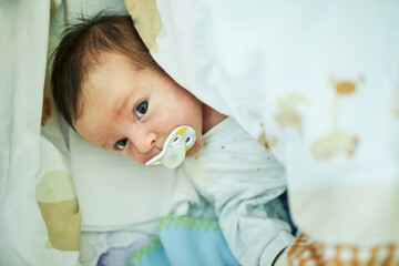 Adorable month old baby with the pacifier