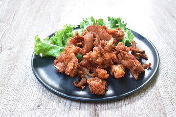 fried crispy salty chicken rib on plate eat couple fresh lettuce vegetable salad