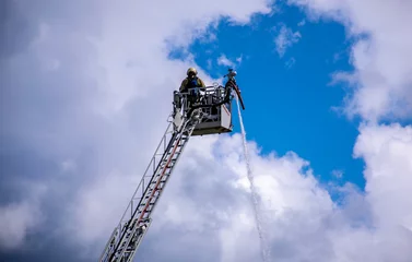 Foto op Plexiglas fireman in the sky © Laurens