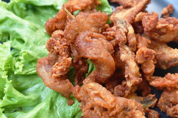 fried crispy salty chicken rib on plate eat couple fresh lettuce vegetable salad