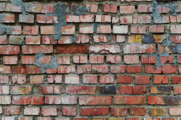 Old and broken brick, a sample of a brick wall in various shades of red, gray, orange and beige,...
