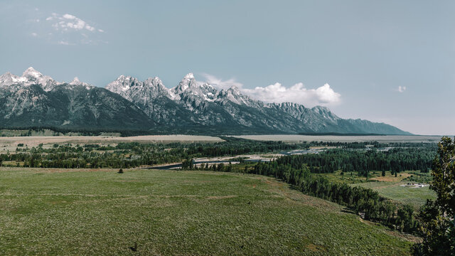 A panoramic view of the Teton Mountain Range, Jackson Hole Valley and the Snake River taken from the Blacktail Butte Mountain in Grand Teton National Park, Wyoming, USA.