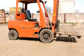 Car - forklift, stacker truck, warehouse forklift. Old car under repair in the garage.