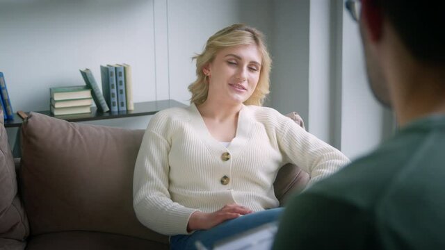 A young woman telling a psychologist her good memories. A professional conducts psychological therapy