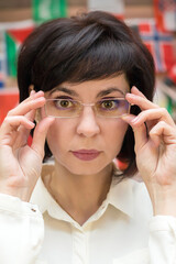 Brunette office worker woman wearing glasses, close-up.