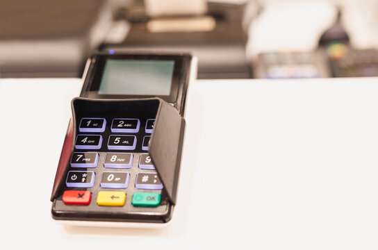 Card reader machine at cashier counter in cafe.