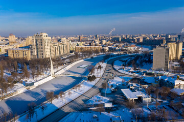 Aerial view of  Kharkiv city, Strelka Square and beautiful bridge above river.  Winter. Ukraine.