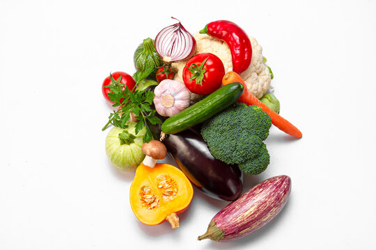 Fresh organic vegetables on a light background. Photo top view. Balanced nutrition concept.