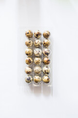 Pack of quail eggs isolated on the white background, top view,easterconcept quail egg uncooked, vegan food diet, kitogenic fat diet