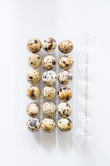 Pack of quail eggs isolated on the white background, top view,easterconcept quail egg uncooked, vegan food diet, kitogenic fat diet