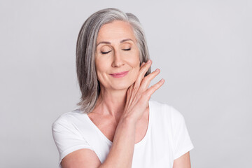 Photo of pretty adorable age woman dressed white outfit smiling closed eyes arm chin isolated grey...